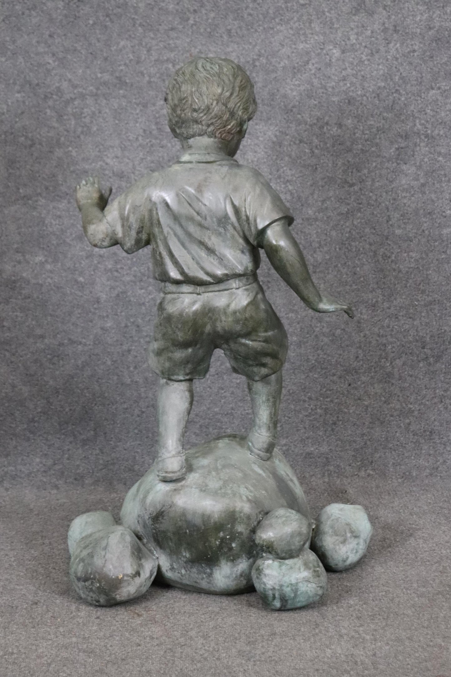 Bronze Elite by Henre in Verdi Gris Outdoor Statue of a Young Boy on a Rock