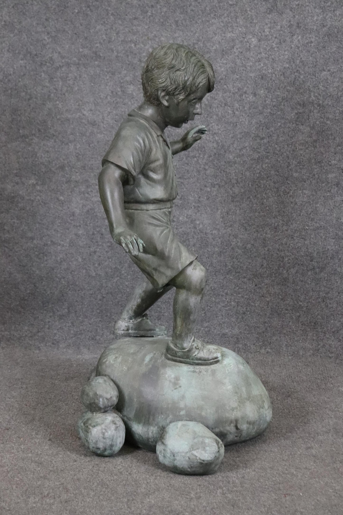 Bronze Elite by Henre in Verdi Gris Outdoor Statue of a Young Boy on a Rock