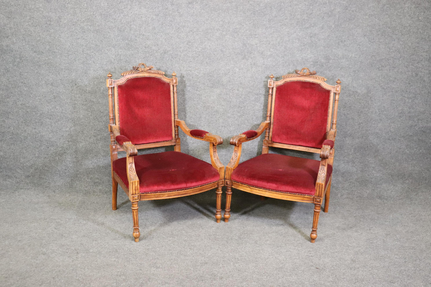 Pair of Carved Walnut Burgundy Velvet Louis XVI Fauteuil Armchairs, circa 1920