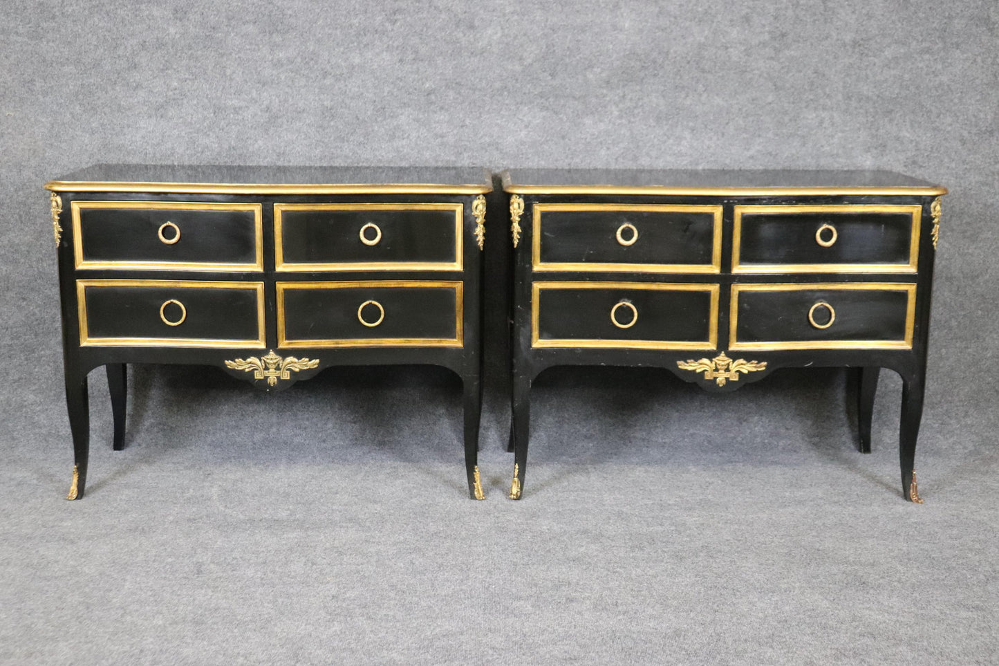 Matched Pair of Maison Jansen style Ebonized and Gilded Louis XV Commodes