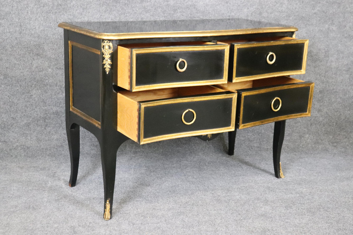 Matched Pair of Maison Jansen style Ebonized and Gilded Louis XV Commodes