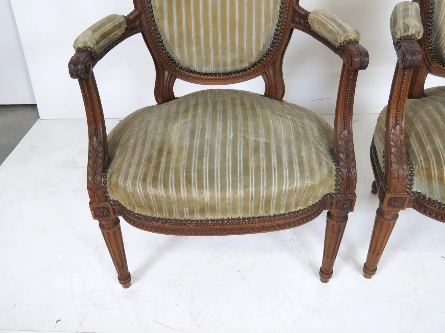 Pair of Antique Louis XVI Style Carved Walnut Fauteuils